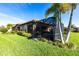 Lush backyard showcasing the screened-in patio, mature trees, and green lawn at 4617 Alexandria Ct, Palmetto, FL 34221