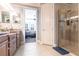 Bright bathroom featuring dual sinks with granite counters, a glass shower and views to bedroom at 4617 Alexandria Ct, Palmetto, FL 34221