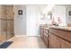 Elegant bathroom featuring dual sinks with granite counters, a glass shower and modern fixtures at 4617 Alexandria Ct, Palmetto, FL 34221
