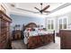 Elegant bedroom featuring a decorative wall, a ceiling fan, and a large window at 4617 Alexandria Ct, Palmetto, FL 34221
