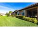 Landscaped front yard leading to a house with a screened-in patio at 4617 Alexandria Ct, Palmetto, FL 34221