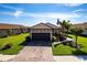 Charming single-story home with a well-manicured lawn, complemented by mature trees and a brick driveway at 4617 Alexandria Ct, Palmetto, FL 34221