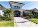 Beautiful home with a stone entrance, meticulously landscaped with colorful flowers and lush tropical plants at 4617 Alexandria Ct, Palmetto, FL 34221