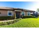 Inviting home exterior with manicured lawn and neatly trimmed hedges lining the walkway to the front door at 4617 Alexandria Ct, Palmetto, FL 34221