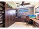 This home office features custom cabinetry, a built-in Murphy bed, and a large desk for optimal organization and productivity at 4617 Alexandria Ct, Palmetto, FL 34221