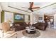 Comfortable living room showcasing tiled floors, modern ceiling fan and neutral decor at 4617 Alexandria Ct, Palmetto, FL 34221