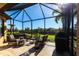 Relaxing screened patio with stylish furniture, and beautiful lawn views at 4617 Alexandria Ct, Palmetto, FL 34221
