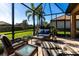 Relaxing screened patio with stylish furniture, and beautiful lawn views at 4617 Alexandria Ct, Palmetto, FL 34221
