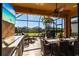 Relaxing screened patio with stylish furniture, outdoor kitchen, and beautiful views at 4617 Alexandria Ct, Palmetto, FL 34221