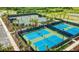 Aerial view of community tennis and pickleball courts surrounded by lush landscaping and black fencing at 4617 Alexandria Ct, Palmetto, FL 34221