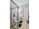 Bright bathroom with a glass enclosed shower and wood-look tile floors at 4856 Coastal Days Ln, Bradenton, FL 34211
