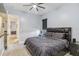 Cozy bedroom featuring neutral decor, carpet flooring, and a ceiling fan at 4856 Coastal Days Ln, Bradenton, FL 34211