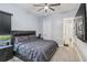 Comfortable bedroom with a ceiling fan and ensuite bathroom entrance at 4856 Coastal Days Ln, Bradenton, FL 34211