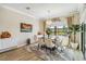 Formal dining room with a modern chandelier, stylish furniture, and natural light at 4856 Coastal Days Ln, Bradenton, FL 34211