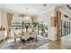 Bright dining area with pool views, stylish furniture, and sophisticated decor at 4856 Coastal Days Ln, Bradenton, FL 34211