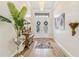Elegant home entryway featuring a decorative chandelier, wood floors, and ornate accents at 4856 Coastal Days Ln, Bradenton, FL 34211