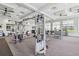 A community fitness center with weightlifting equipment, televisions, and large windows at 4856 Coastal Days Ln, Bradenton, FL 34211