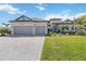 Beautifully landscaped single-Gathering home with a three-car garage and a paver driveway at 4856 Coastal Days Ln, Bradenton, FL 34211