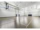 Spacious gymnasium with basketball hoops, bright lighting, and well-maintained hardwood floor court at 4856 Coastal Days Ln, Bradenton, FL 34211