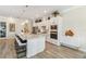 Contemporary kitchen boasts a large center island with pendant lighting and stainless steel appliances at 4856 Coastal Days Ln, Bradenton, FL 34211