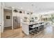 Bright kitchen features a long center island with barstool seating and stainless steel appliances at 4856 Coastal Days Ln, Bradenton, FL 34211