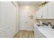 Laundry room with washer, dryer, and storage cabinets at 4856 Coastal Days Ln, Bradenton, FL 34211