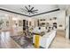 Open-concept living room leading to kitchen with ample seating and natural light, and view of the entryway at 4856 Coastal Days Ln, Bradenton, FL 34211