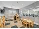 Bright playroom with a playhouse, table and chairs, and a view of the gym area at 4856 Coastal Days Ln, Bradenton, FL 34211