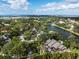 Picturesque aerial view of a residential neighborhood featuring mature trees and waterways at 49 Osprey Point Dr, Osprey, FL 34229