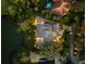 Aerial nighttime view of a luxury home with a private pool, set beside a tranquil pond at 49 Osprey Point Dr, Osprey, FL 34229