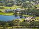 Breathtaking aerial view showcasing the golf course, clubhouse, lake, and surrounding luxury homes at 49 Osprey Point Dr, Osprey, FL 34229