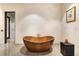 Tranquil bathroom showcasing a freestanding copper tub, elegant tiling, and modern design elements at 49 Osprey Point Dr, Osprey, FL 34229