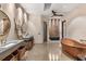 Elegant bathroom featuring double sinks, a copper soaking tub, and stylish modern fixtures at 49 Osprey Point Dr, Osprey, FL 34229