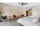 Spacious bedroom offers modern decor with a light-colored brick accent wall, recessed lighting, and outdoor views at 49 Osprey Point Dr, Osprey, FL 34229