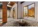 Zen courtyard with stone fountain, pebble ground cover, and serene views through floor to ceiling windows at 49 Osprey Point Dr, Osprey, FL 34229