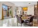 Bright dining area with modern finishes, a decorative fireplace, and views of the landscaped exterior at 49 Osprey Point Dr, Osprey, FL 34229