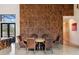 Stylish dining room with wood-paneled wall and seating for six at 49 Osprey Point Dr, Osprey, FL 34229