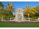 Welcoming entrance to the Oaks Club, marked by a grand sign and lush landscaping with manicured lawns at 49 Osprey Point Dr, Osprey, FL 34229