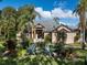 Charming single-story home with mature landscaping and a well-maintained lawn at 49 Osprey Point Dr, Osprey, FL 34229