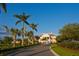 Elegant clubhouse exterior with stately columns, porte-cochere and lush landscaping creating a sophisticated ambiance at 49 Osprey Point Dr, Osprey, FL 34229