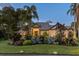 Beautiful home exterior with well-maintained landscaping and mature trees at dusk at 49 Osprey Point Dr, Osprey, FL 34229