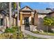 This home features manicured landscaping, stone walkway, and a contemporary front entrance with wood accents at 49 Osprey Point Dr, Osprey, FL 34229