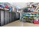 Spacious garage with overhead storage, black cabinets, and bikes at 49 Osprey Point Dr, Osprey, FL 34229