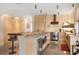 Contemporary kitchen with sleek cabinets, stainless steel appliances, a wine cooler, and a breakfast bar at 49 Osprey Point Dr, Osprey, FL 34229