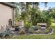 Beautiful landscaped garden with unique potted plants and stone accents at 49 Osprey Point Dr, Osprey, FL 34229