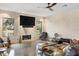 Bright living area with a large television, fireplace, and large windows overlooking the outdoor scenery at 49 Osprey Point Dr, Osprey, FL 34229