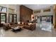 Expansive living room with high ceilings, stone accents, and a luxurious leather sectional at 49 Osprey Point Dr, Osprey, FL 34229