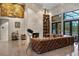 Cozy living room featuring a stone fireplace, unique art, and ample seating for entertaining at 49 Osprey Point Dr, Osprey, FL 34229