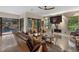 Relax in this well-lit living room that features outdoor views and access to the screened-in outdoor living space at 49 Osprey Point Dr, Osprey, FL 34229