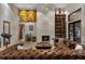 Inviting living room showcasing a fireplace, elegant artwork, and comfortable seating arrangements at 49 Osprey Point Dr, Osprey, FL 34229